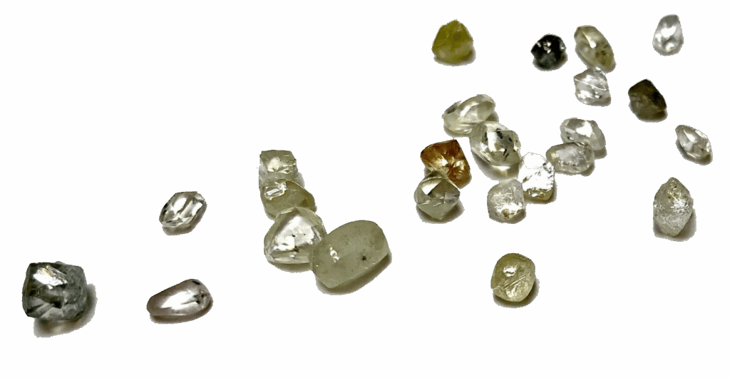 Verschillende ruwe natuurlijke diamanten van verschillende kleuren verspreidt random.